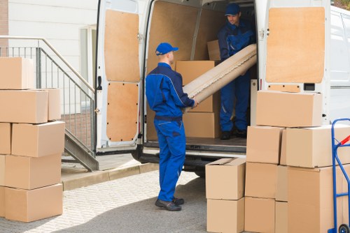 Moving boxes and furniture being carefully handled in Kingston