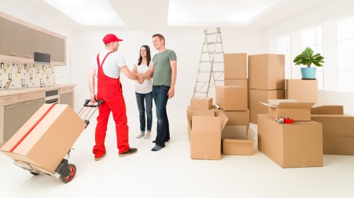 Helper carrying furniture during a Kingston house move