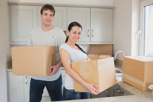 Careful handling of belongings in a Kingston flat staircase
